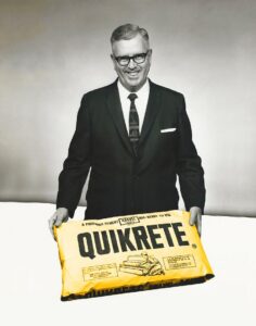 Older gentleman holding a bag of Quikrete.